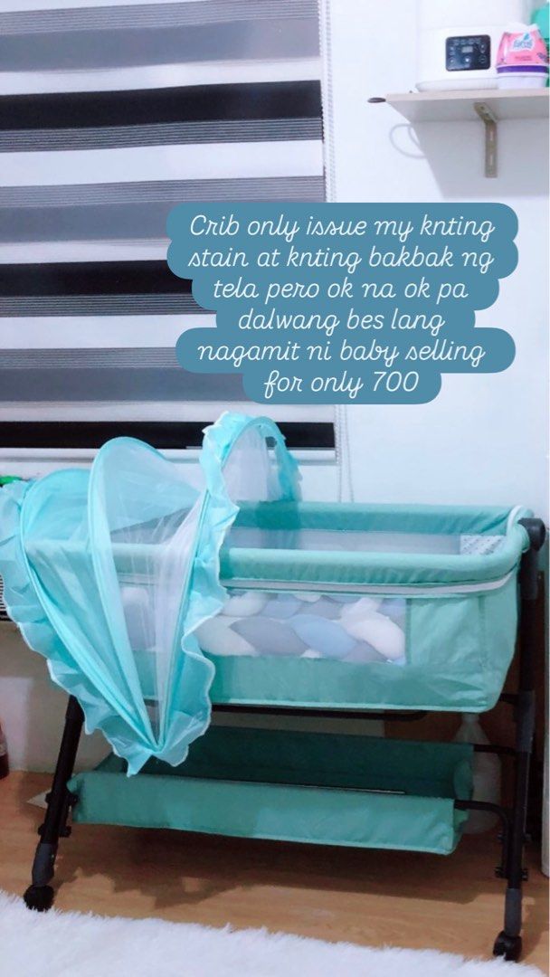 Baby Crib with Mosquito Net (Category: Cots & Cribs) located in Cavite. Submitted by butfirstdecluttering (Listing ID 1424157683, Image 1). Description: - Baby crib with mosquito net - Teal frame - Includes a storage shelf - Light-colored interior with patterned design - Minor knitting stain on fabric Issue my knting stain di msydo kta pero natatanggl nmn at my bakbak sa tela ntatamaan ksi ng upuan pero ok na ok pa di msyado ngmt ni baby .