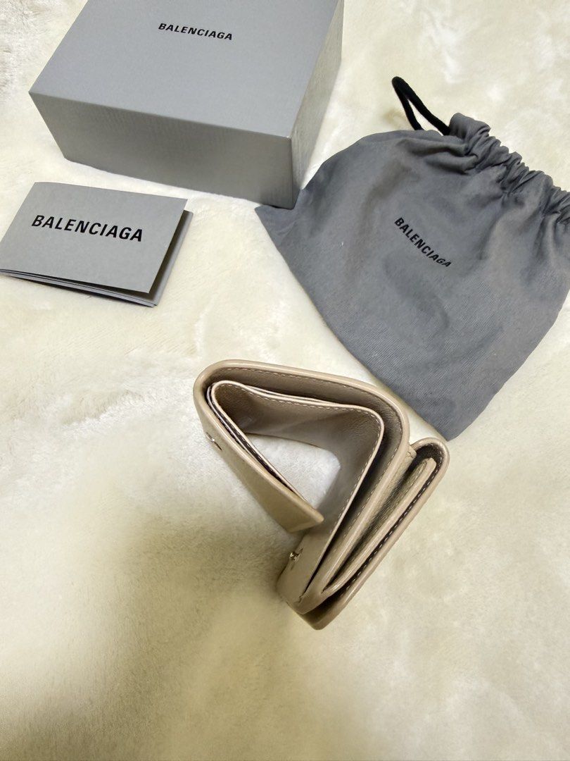 Balenciaga Cash Mini Wallet (Category: Luxury Bags & Wallets) located in Manila. Submitted by cm_luxe (Listing ID 1424147556, Image 3). Description: - Authentic Balenciaga Cash Mini Wallet - Neutral beige color - Includes original box, dust bag, and care cards - Snap closure - Multiple card slots - Compact and stylish design - Balenciaga logo on front 100💯 Authentic.