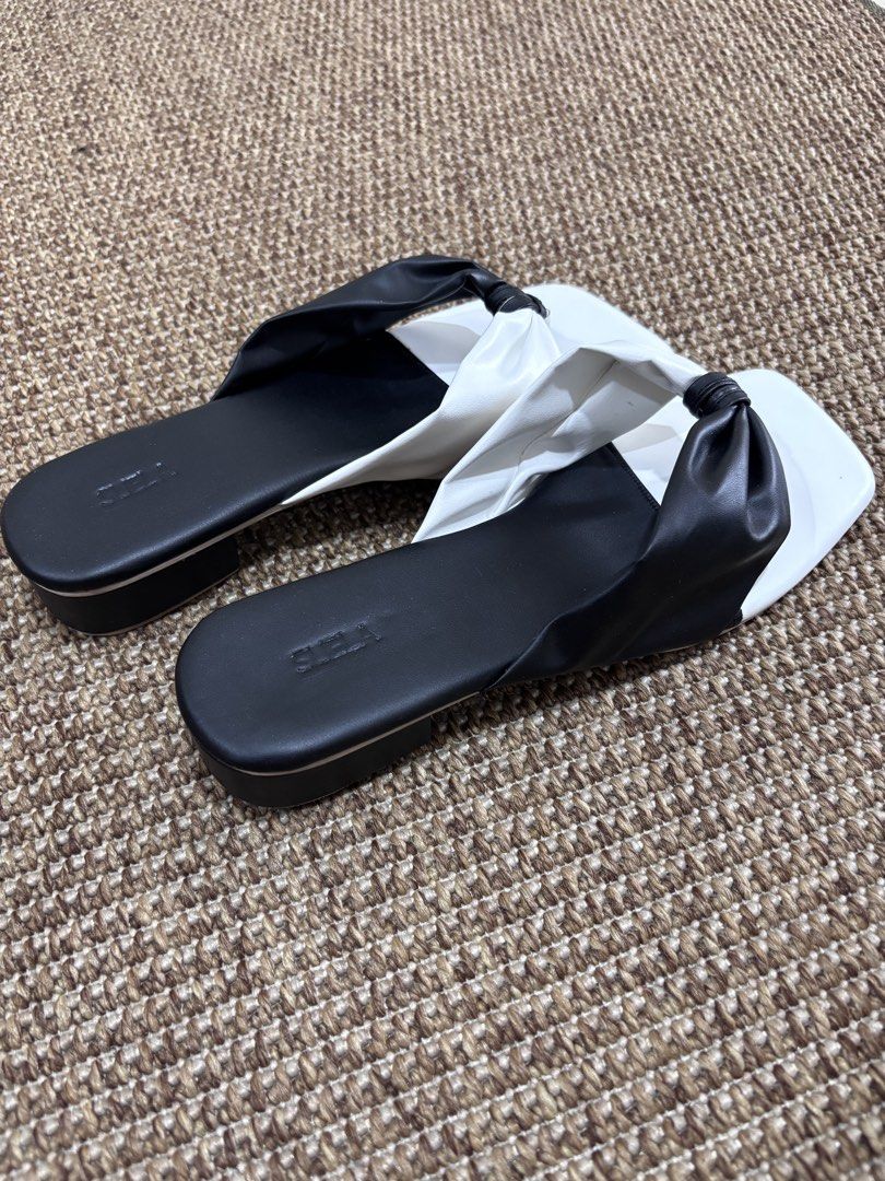 Black and White Knot Sandals (Category: Flats & Sandals) located in Caloocan City. Submitted by stuff_shop (Listing ID 1423980807, Image 3). Description: - Stylish two-tone sandals - Features a knot detail - Square toe design - Small heel - Comfortable footbed - soft, padded insole - Perfect for everyday use.