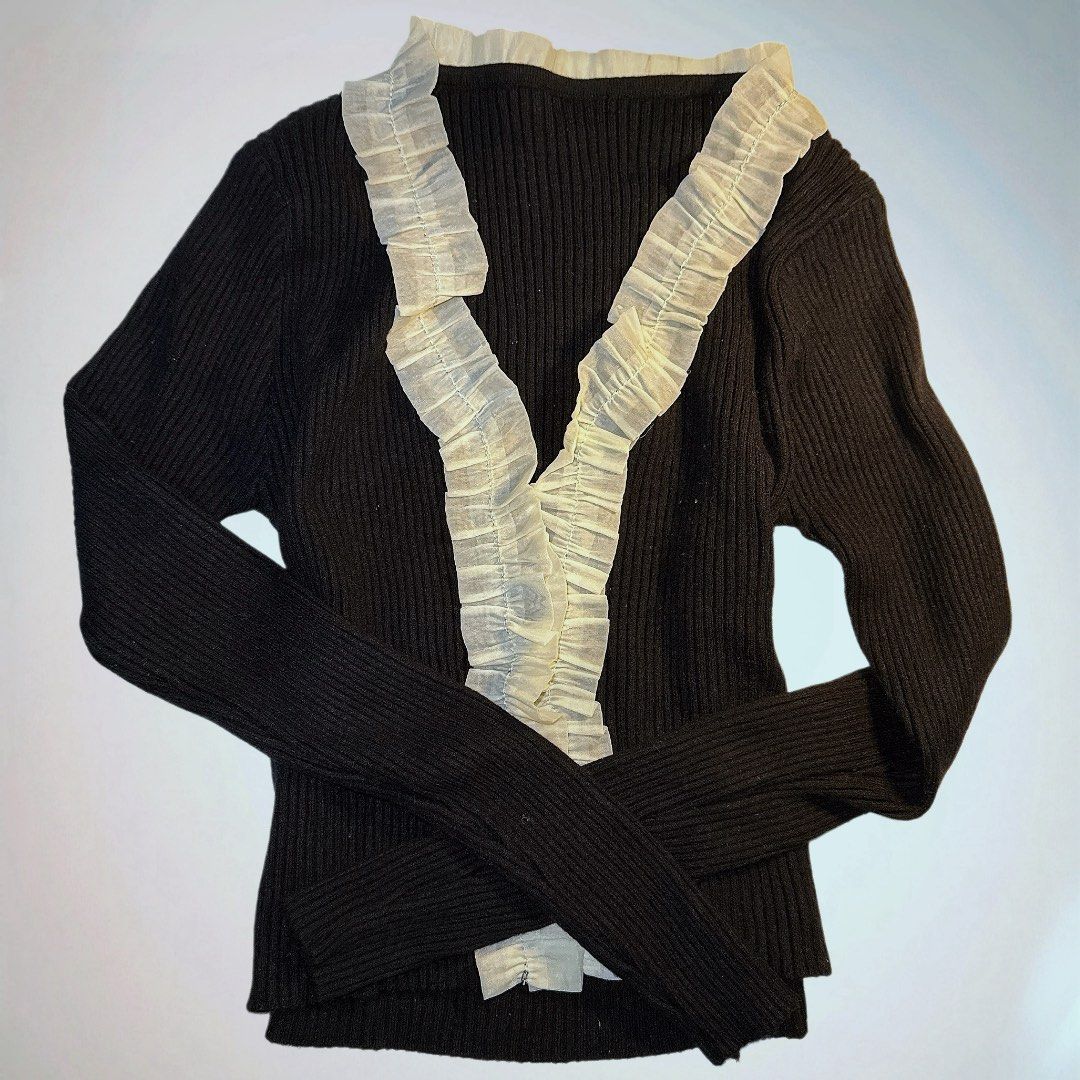 Black Ribbed Sweater with Ruffle Detail (Category: Longsleeves) located in Manila. Submitted by aveileu (Listing ID 1424043759, Image 1). Description: - Black ribbed knit sweater - Long sleeves - V-neckline with ruffle trim - Fitted style - Versatile for layering or standalone wear.