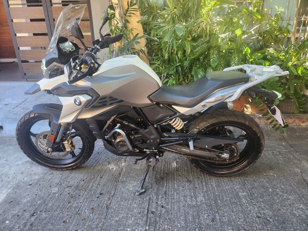 BMW G 310 GS Motorcycle (Category: Motorbikes for Sale) located in Marikina City. Submitted by dc778w (Listing ID 1424047906, Image 1). Description: BMW G 310 GS motorcycle. Features a white and grey color scheme. The motorcycle has a digital display showing 2836 km. Includes a windshield and rear rack. The motorcycle is equipped with a single exhaust. Lowering kit installed already. Complere with casa record from BMW daang hari. Easytrip & Autos