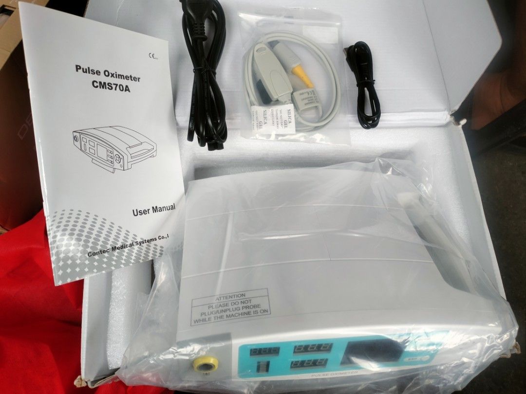 Contec CMS70A Pulse Oximeter (Category: Medical Supplies & Tools) located in Quezon City. Submitted by delvallelj58229 (Listing ID 1424057743, Image 1). Description: The image shows a Contec CMS70A Rechargeable / Mains Operated Desktop Pulse Oximeter. Function: Measures pulse oxygen saturation (\(SpO_{2}\)) and pulse rate (\(PR\)) through a finger sensor. Key Features: Includes a TFT screen and LED display, pulse waveform display, and menu operat