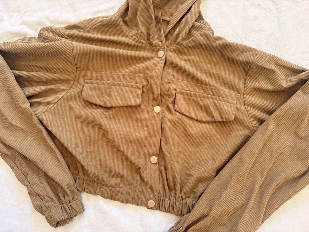Corduroy Crop Hoodie Jacket (Category: Coats, Jackets and Outerwear) located in Abucay. Submitted by rewornstudio (Listing ID 1423994325, Image 2). Description: - Olive green corduroy crop jacket - Hooded - Two front pockets - Button-up closure - Long sleeves with elastic cuffs - Drawstring hem - Cropped style - Perfect for layering.