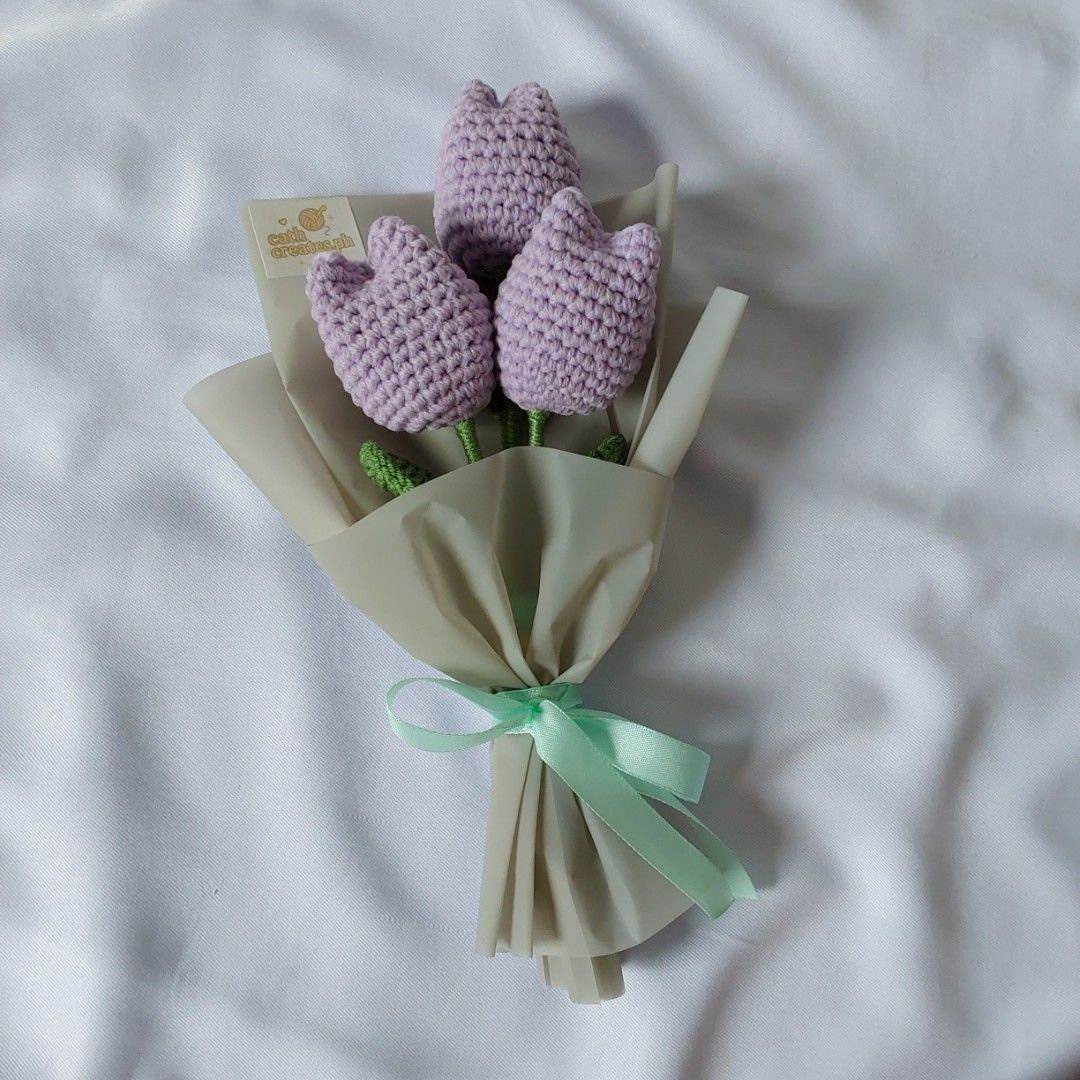 Crochet Tulip Bouquet (Category: Flowers & Bouquets) located in Cebu City. Submitted by starlinggg (Listing ID 1424046111, Image 1). Description: - Handmade crochet tulip bouquet - Includes three lavender tulips - Green stems - Wrapped in beige paper - Tied with a mint green ribbon - Perfect for gifts or home decor.