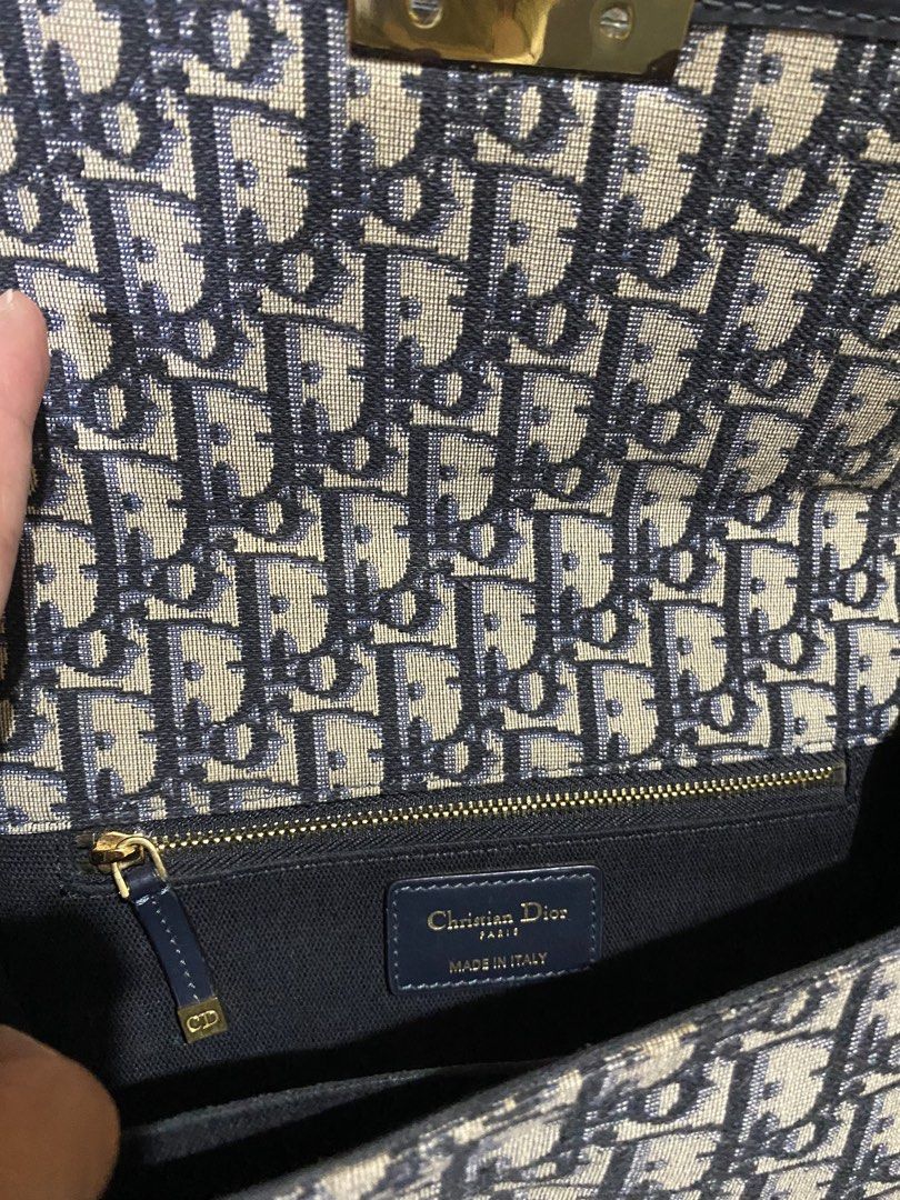Dior MontaigneBag (Category: Luxury Bags & Wallets) located in Gattaran. Submitted by sweet_relove (Listing ID 1424117881, Image 3). Description: - Dior Montaigne Bag - Iconic Dior Oblique canvas - Navy blue leather trim - Gold-tone CD clasp - Detachable shoulder strap - Interior zip pocket - "Christian Dior Paris Made in Italy" leather tag - Serial number: 09-BO-0129.