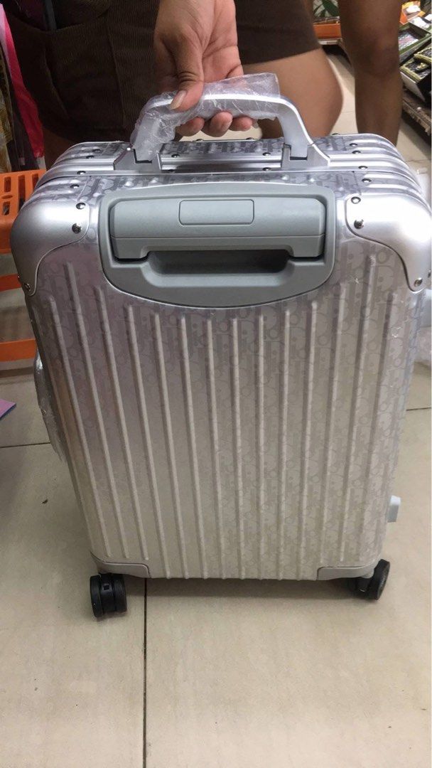 Dior Rimowa Suitcase (Category: Luxury Bags & Wallets) located in Manila. Submitted by louievicocollections (Listing ID 1424050335, Image 3). Description: - Dior x Rimowa Silver Suitcase - Iconic Dior logo pattern - Retractable handle and multi-wheel system - Secure combination lock - Interior lined with Dior logo fabric - Includes straps and compartments for organization.