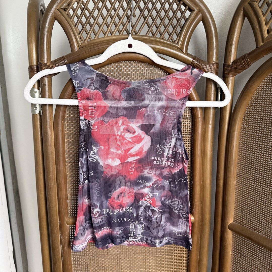 Floral Mesh Boat Neck Top (Category: Sleeveless) located in Tarlac. Submitted by gemini___sun (Listing ID 1424062450, Image 1). Description: - Unique floral print with roses and text overlay - Sheer mesh material - Sleeveless design - Scoop neck - Fitted silhouette - Color palette: Red, black, and white - Perfect for layering or wearing alone.