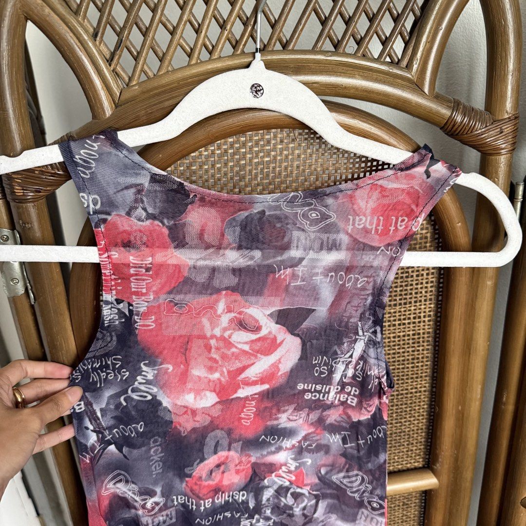 Floral Mesh Boat Neck Top (Category: Sleeveless) located in Tarlac. Submitted by gemini___sun (Listing ID 1424062450, Image 2). Description: - Unique floral print with roses and text overlay - Sheer mesh material - Sleeveless design - Scoop neck - Fitted silhouette - Color palette: Red, black, and white - Perfect for layering or wearing alone.