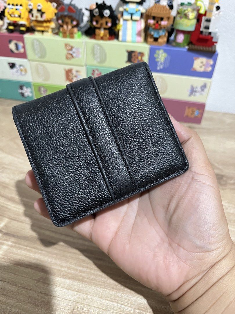 Fossil Emery Small Snap Bifold Black Leather Wallet (Category: Wallets & Card holders) located in Cagayan de Oro. Submitted by takinasphere (Listing ID 1424049858, Image 2). Description: - Black leather Fossil wallet - Snap closure - Gold-tone buckle detail - Interior with card slots and ID window - Fossil logo inside - Compact and stylish design.
