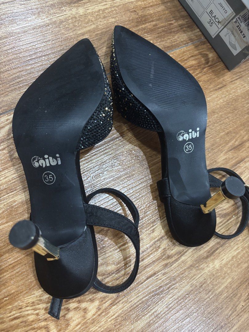 Gibi Black Heels Size 35 (Category: Heels) located in San Juan City. Submitted by ____aiceee____ (Listing ID 1424039632, Image 3). Description: Elegant black heels from Gibi, size 35. Features a pointed toe design with sparkling embellishments. Includes an ankle strap with a buckle closure. The heels have a gold-colored accent. The soles are black. The heels come with the original box. Bought for P2,199.75 / Used once .