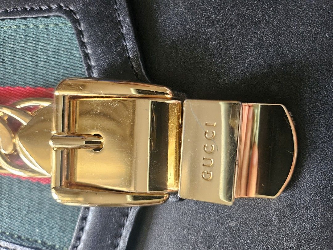 Gucci Sylvie Leather Shoulder Bag (Category: Luxury Bags & Wallets) located in Manila. Submitted by arlenitian76248 (Listing ID 1424098346, Image 3). Description: - Authentic Gucci Sylvie shoulder bag - Black leather - Gold-tone chain and buckle closure - Signature green and red stripe detail - Detachable shoulder strap with red, navy, and green stripes - Interior slip pocket - Includes Gucci La Tigre card.