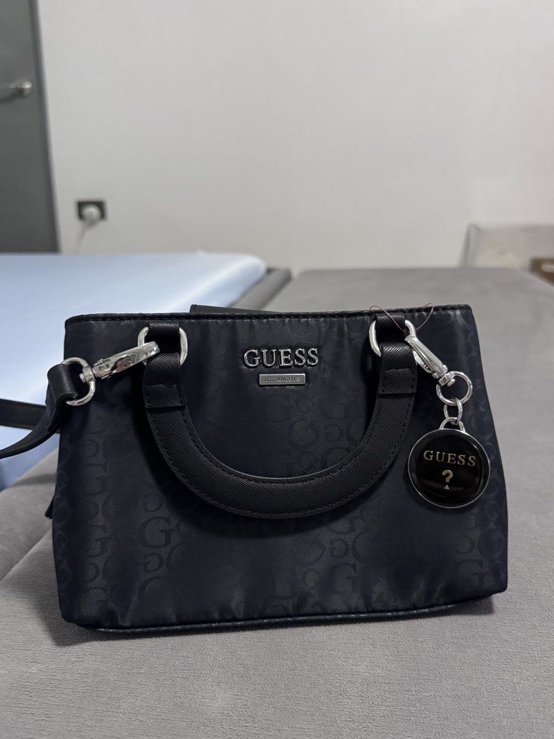 Guess Black Bag (Category: Shoulder Bags) located in Cavite. Submitted by kaokao_declutter (Listing ID 1424073614, Image 1). Description: Unused, bought from japan pero never na use there or here sa ph, decluttering bag collection na.