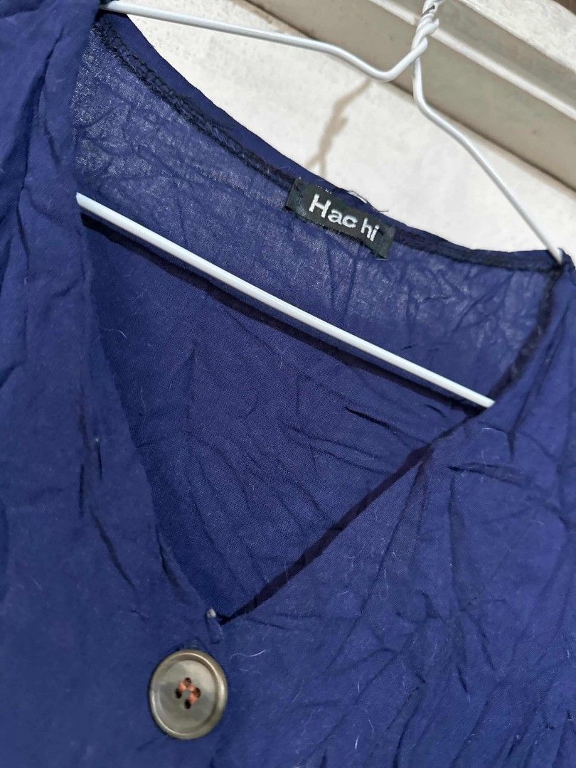 Hachi Navy Blue Dress (Category: Dresses) located in Pasig City. Submitted by rkclosets (Listing ID 1424035670, Image 2). Description: - Hachi navy blue dress - V-neck design - Button-down front - Tie-waist feature - Short sleeves - Textured fabric - Perfect for everyday wear.