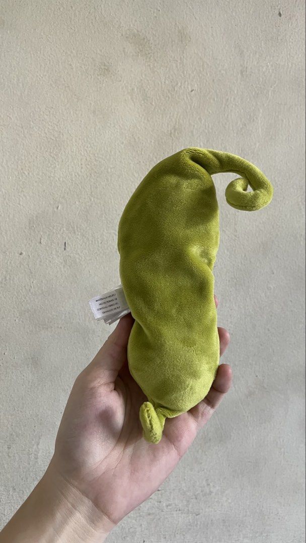 Jellycat Amuseable Pea in Pod Plush Toy (Category: Plushies & Soft Toys) located in Quezon City. Submitted by jellycooties (Listing ID 1423992205, Image 3). Description: - Jellycat Amuseable Pea in Pod plush toy - Features a smiling pea character - Nestled inside a soft, green pod - Includes the Jellycat tag - Has a loop at the top and a small tail at the bottom - Made of soft, plush material.