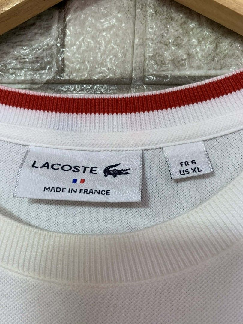 Lacoste White Pocket T-Shirt (Category: Tshirts & Polo Shirts ) located in Caloocan City. Submitted by vintstreets (Listing ID 1424102952, Image 3). Description: LACOSTE 💎Dimes: Width: 22 Length: 29 💎Condi&CR: 9.3/10 📍issue: dot stain hindi ganun ka visible 📍dirt sa likod (see details) ⬇️ 💎solid condition nito - Lacoste T-shirt - Size: US XL (FR 6) - Features a pocket with a red zipper - Crew neck with red and navy blue accents - Lacoste log