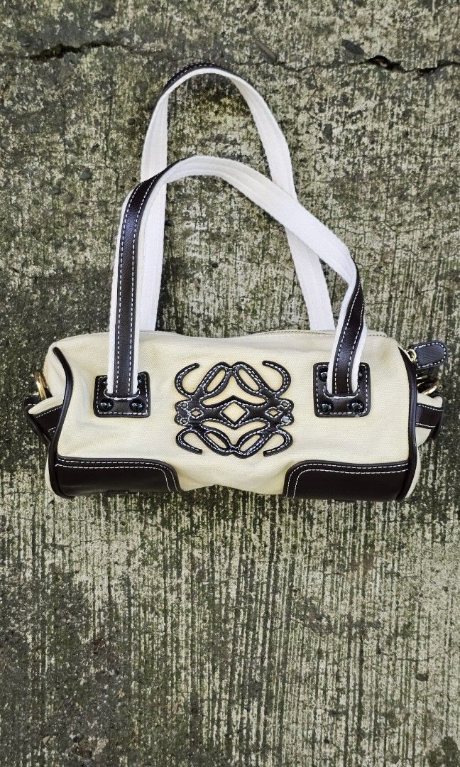 Loewe Amazona ClothBag (Category: Luxury Bags & Wallets) located in Kibawe. Submitted by Thrift_ni_Babac (Listing ID 1424116646, Image 1). Description: Loewe Canvas & Leather Barrel Bag ​Add a touch of classic luxury to your collection with this chic Loewe barrel bag. Designed with a durable cream canvas body and elegant dark brown leather accents. ​Details: Features the iconic Loewe anagram logo stitched on the front and a leather interior heat 