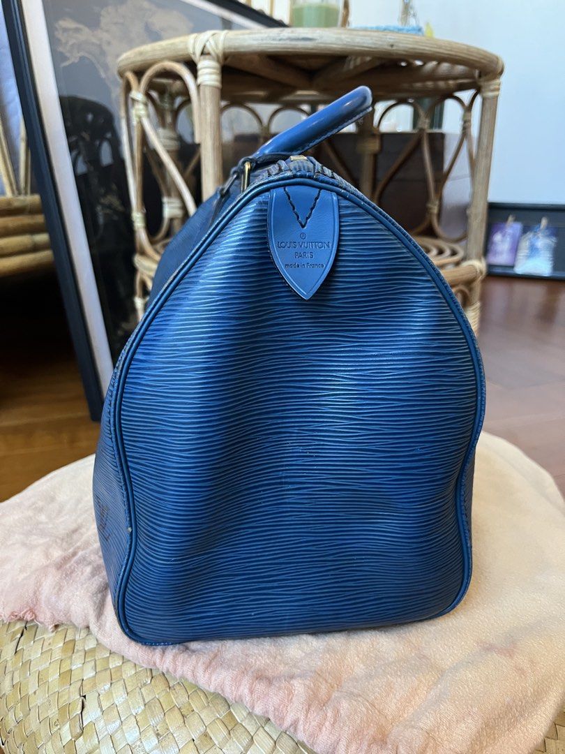 Louis Vuitton Epi Speedy 30 Blue (Category: Luxury Bags & Wallets) located in Rizal. Submitted by jn_mdl (Listing ID 1424060008, Image 3). Description: - Authentic Louis Vuitton Epi Speedy 30 - Color: Blue - Features: Top zip closure, rolled leather handles, interior slip pocket, - Includes: Padlock (no key) and dustbag - Condition: GOOD. Shows wear on corners and handles; clean interior - Made in France -Serial number: VI0922 -Check photos for d