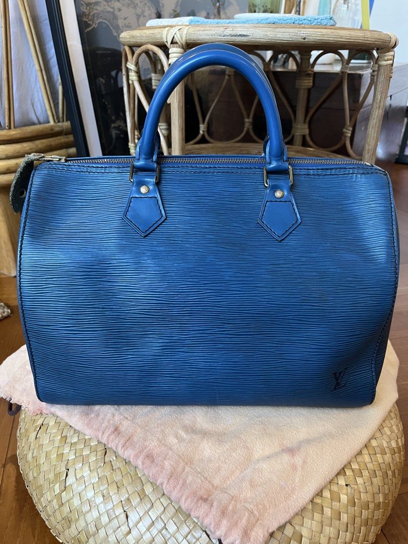 Louis Vuitton Epi Speedy 30 Blue (Category: Luxury Bags & Wallets) located in Rizal. Submitted by jn_mdl (Listing ID 1424060008, Image 1). Description: - Authentic Louis Vuitton Epi Speedy 30 - Color: Blue - Features: Top zip closure, rolled leather handles, interior slip pocket, - Includes: Padlock (no key) and dustbag - Condition: GOOD. Shows wear on corners and handles; clean interior - Made in France -Serial number: VI0922 -Check photos for d