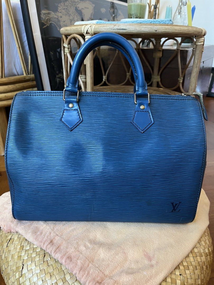 Louis Vuitton Epi Speedy 30 Blue (Category: Luxury Bags & Wallets) located in Rizal. Submitted by jn_mdl (Listing ID 1424060008, Image 2). Description: - Authentic Louis Vuitton Epi Speedy 30 - Color: Blue - Features: Top zip closure, rolled leather handles, interior slip pocket, - Includes: Padlock (no key) and dustbag - Condition: GOOD. Shows wear on corners and handles; clean interior - Made in France -Serial number: VI0922 -Check photos for d