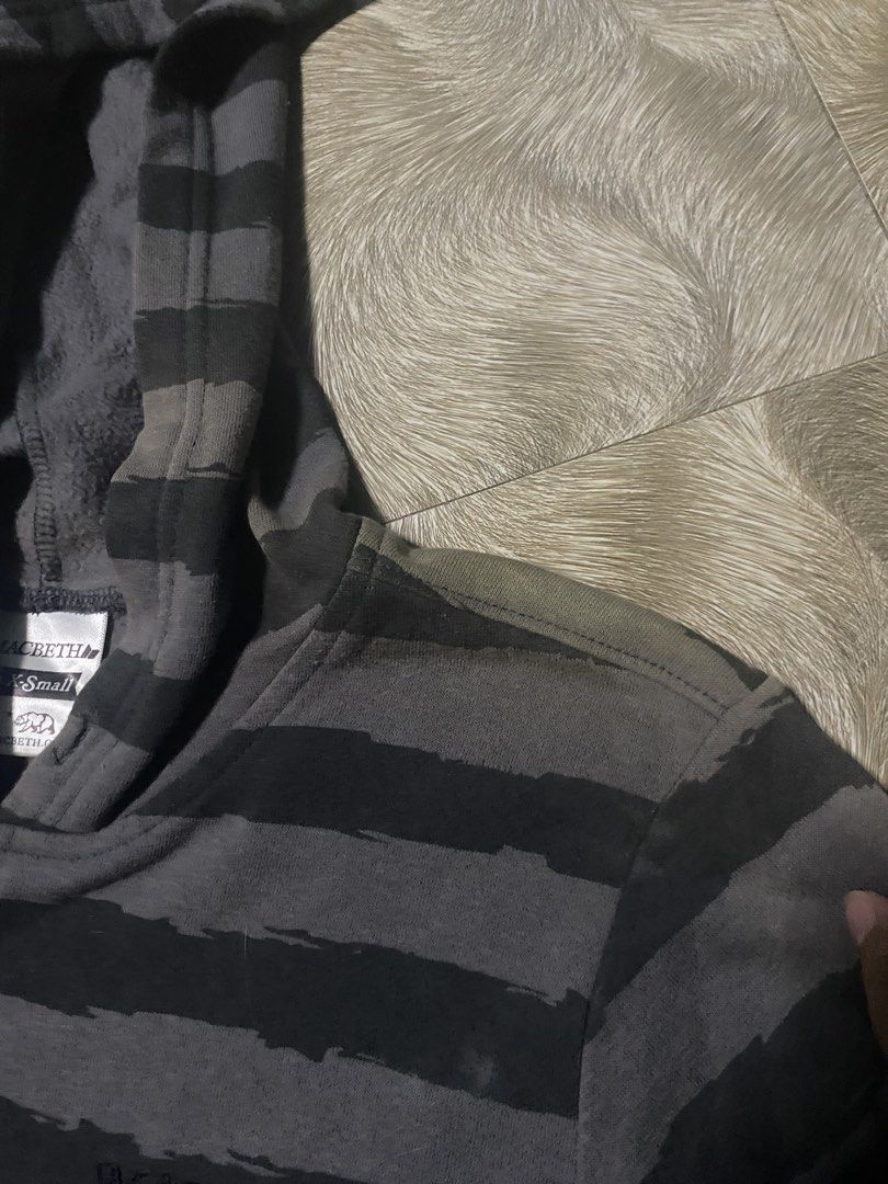 Macbeth Striped Hoodie - XS (Category: Hoodies) located in Caloocan City. Submitted by senglavs (Listing ID 1424060172, Image 3). Description: Macbeth hoodie in gray and black stripes. Features a hood and a front pocket. The size is XS. The hoodie has the Macbeth logo on the chest. Measurements are approximately 23 inches in length and 17.5inches across the chest. The sleeve length is about 7inches Issue: may kupas sa bandang shoulder Loc. North 