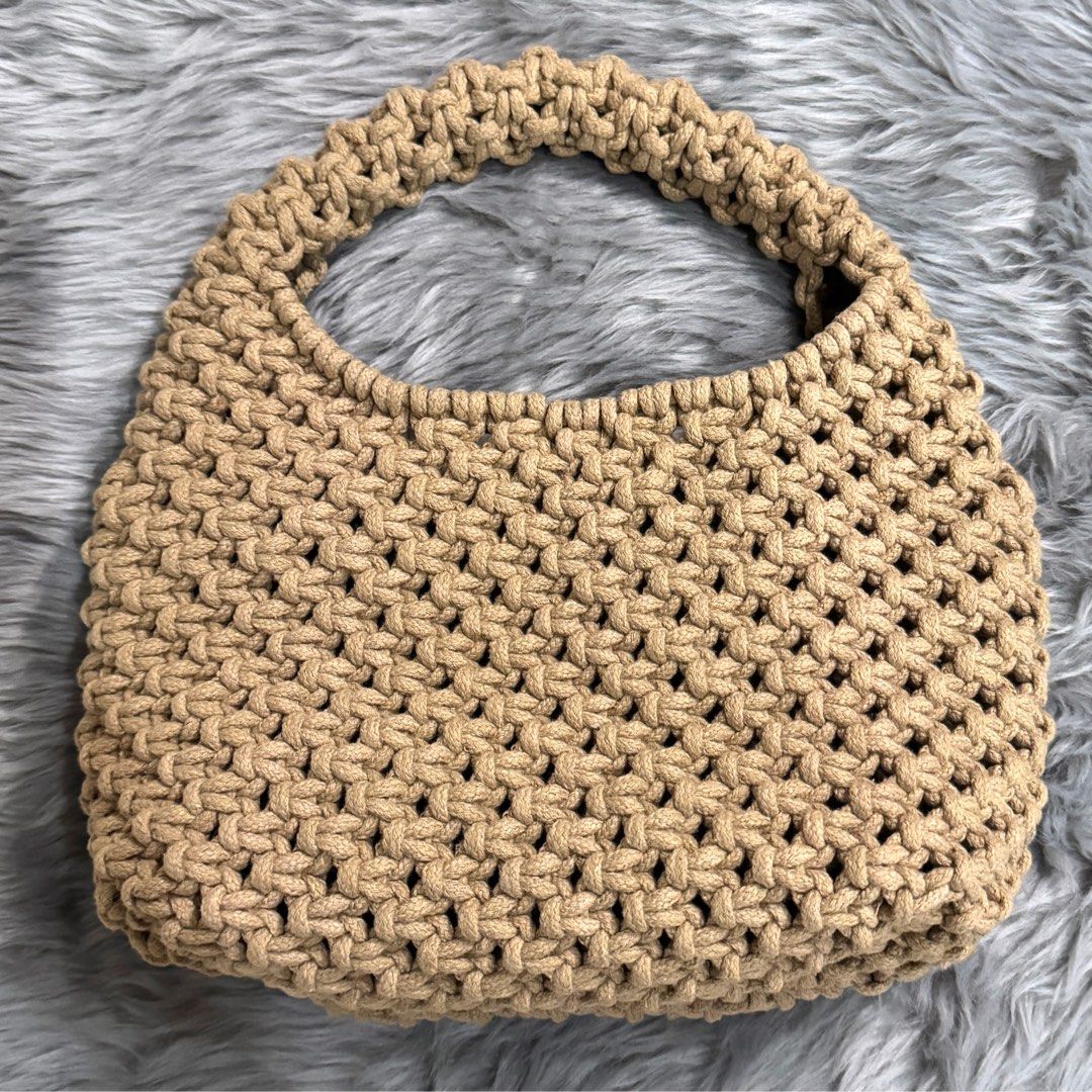 Macrame Handbag (Category: Shoulder Bags) located in Pasig City. Submitted by sinta_studio (Listing ID 1423976706, Image 1). Description: - Beige macrame handbag - Woven design - Sturdy handle - Well-made - Ideal for carrying essentials.