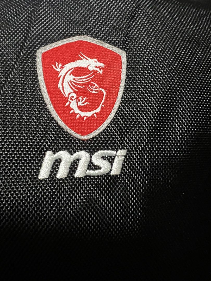 MSI Gaming Backpack (Category: Backpacks) located in Dasmarinas. Submitted by corruptdot (Listing ID 1424025069, Image 1). Description: - Black MSI gaming backpack with red accents - Features the MSI logo - Multiple compartments for storage - Dragon logo zipper pulls - Made of durable, textured material.