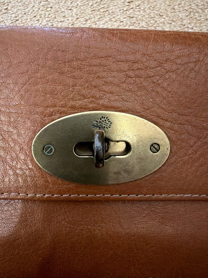 Mulberry Leather Wallet (Category: Luxury Bags & Wallets) located in Siquijor. Submitted by inkedcuratedluxe (Listing ID 1423983408, Image 2). Description: - Authentic Mulberry leather wallet - Classic design with secure clasp closure - Multiple compartments for cards and cash - Includes a zippered pocket - Crafted from high-quality leather - Features the Mulberry logo - Stylish and functional accessory.