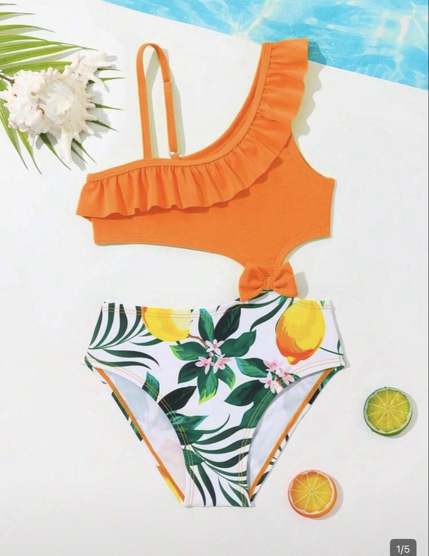 Orange Ruffle One-Shoulder Swimsuit (Category: Bikinis & Swimsuits) located in Taguig. Submitted by amara2021 (Listing ID 1423975636, Image 1). Description: - Vibrant orange top with ruffle detail - Fun lemon and leaf print bottom - Unique cutout design - Adorable bow accent - Ideal for beach or pool days 2-4 yrs old please see attached photo for body reference.