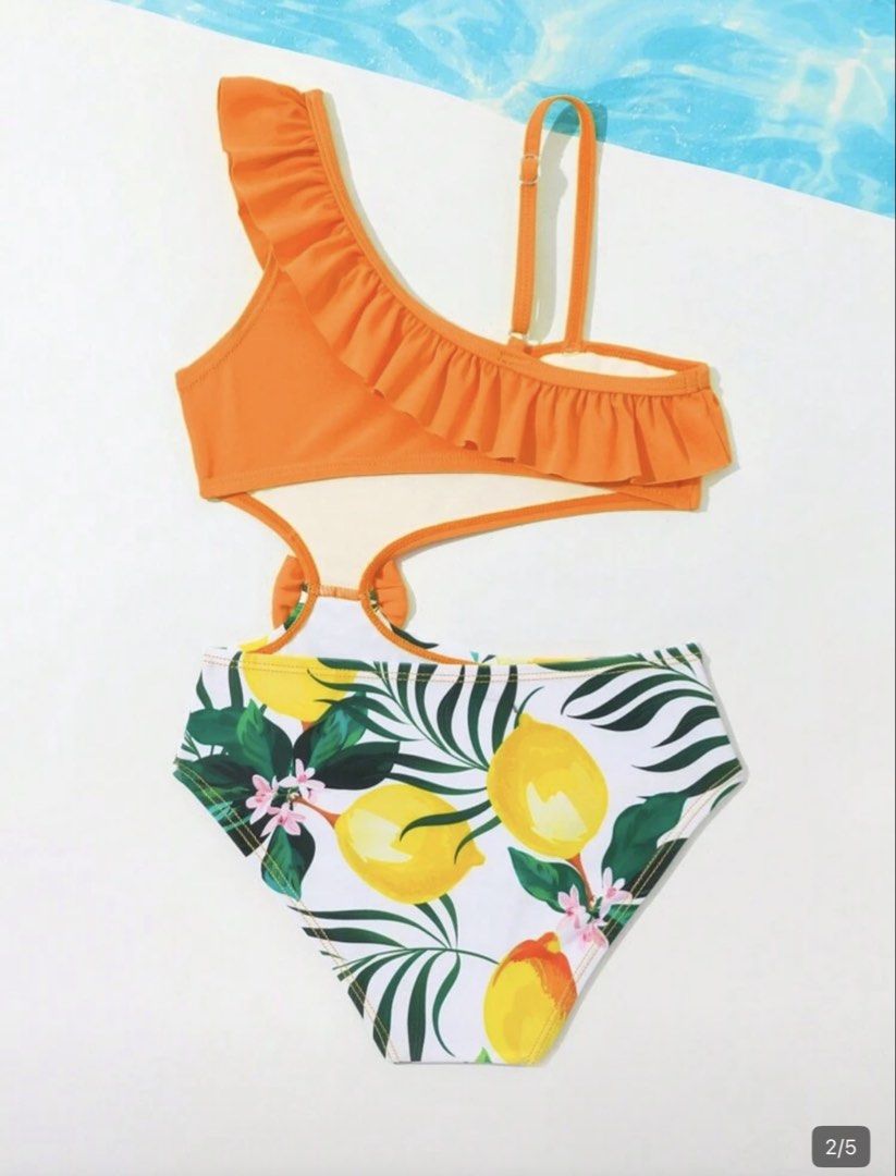 Orange Ruffle One-Shoulder Swimsuit (Category: Bikinis & Swimsuits) located in Taguig. Submitted by amara2021 (Listing ID 1423975636, Image 2). Description: - Vibrant orange top with ruffle detail - Fun lemon and leaf print bottom - Unique cutout design - Adorable bow accent - Ideal for beach or pool days 2-4 yrs old please see attached photo for body reference.