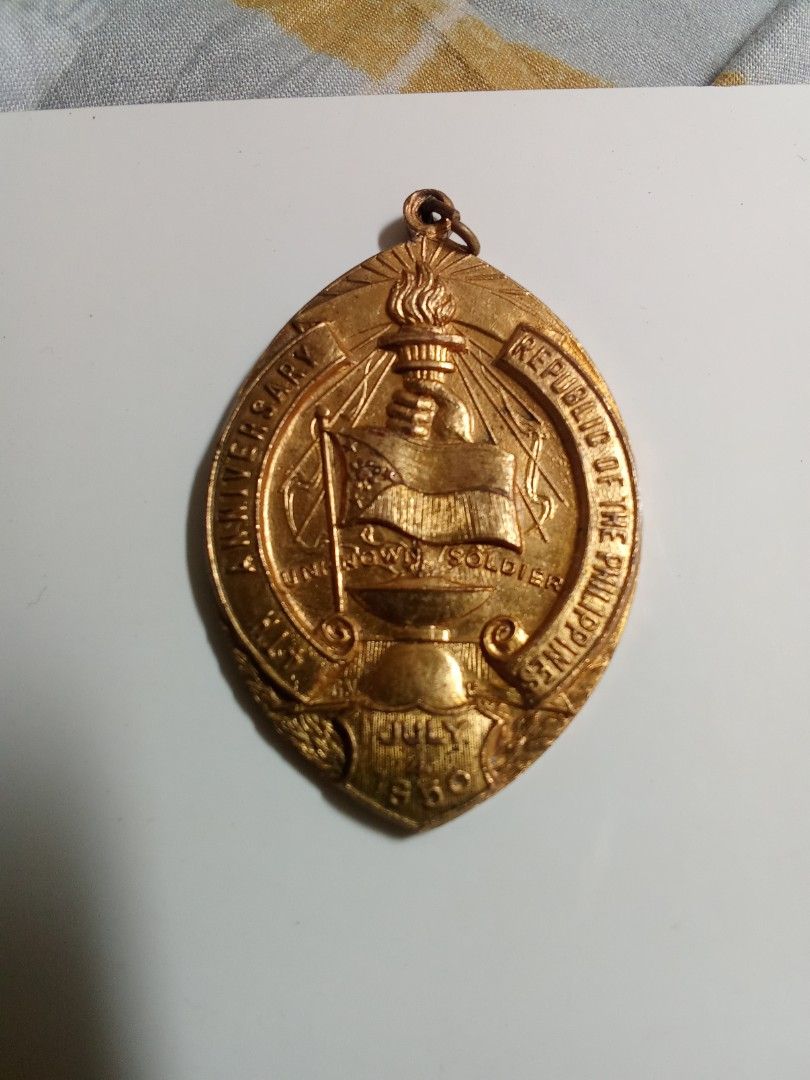 Philippine Republic Anniversary Medal (Category: Currency) located in Quezon City. Submitted by mogan27 (Listing ID 1424119201, Image 1). Description: Vintage medal commemorating the anniversary of the Republic of the Philippines. Features a torch, the Philippine flag, and the words "Republic of the Philippines" and "Anniversary". The date "July 4, 1950" is visible. The back of the medal has the word "Manila" inscribed. A great piece for collecto