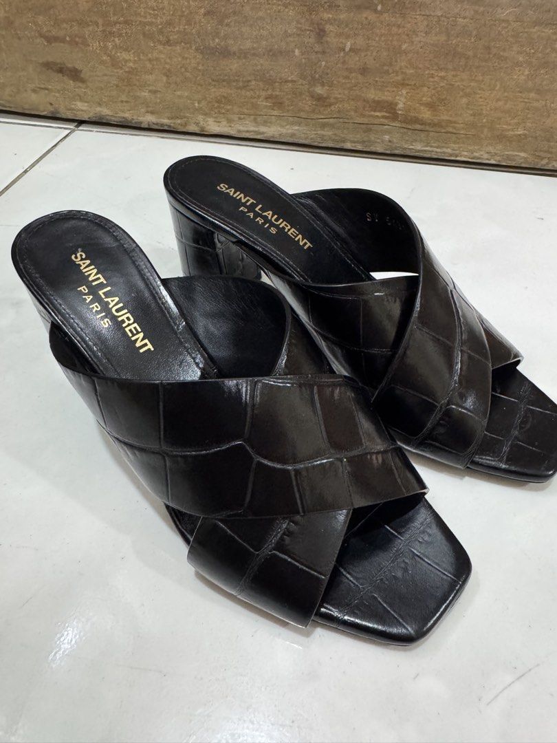 Saint Laurent Black Leather Sandals Size 35 (Category: Sneakers & Footwear) located in Pasig City. Submitted by ginaramos (Listing ID 1424038403, Image 1). Description: - Authentic Saint Laurent sandals - Black leather - Size 35 - Made in Italy - Criss-cross strap design - Block heel - Visible Saint Laurent logo - Minor wear on sole.