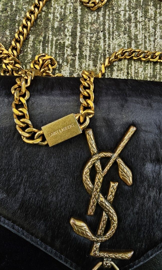 Saint Laurent Kate Tassel Chain Bag (Category: Luxury Bags & Wallets) located in Kibawe. Submitted by Thrift_ni_Babac (Listing ID 1424109827, Image 2). Description: FOR SALE: Saint Laurent (YSL) Kate Tassel Chain Bag ​Saint Laurent Kate Bag in black leather with rare python-textured YSL logo and gold-tone hardware. ​Condition: Pre-owned. Shows natural leather grain and minor wear on the interior/edges (see photos for details). ​Features: Iconic m