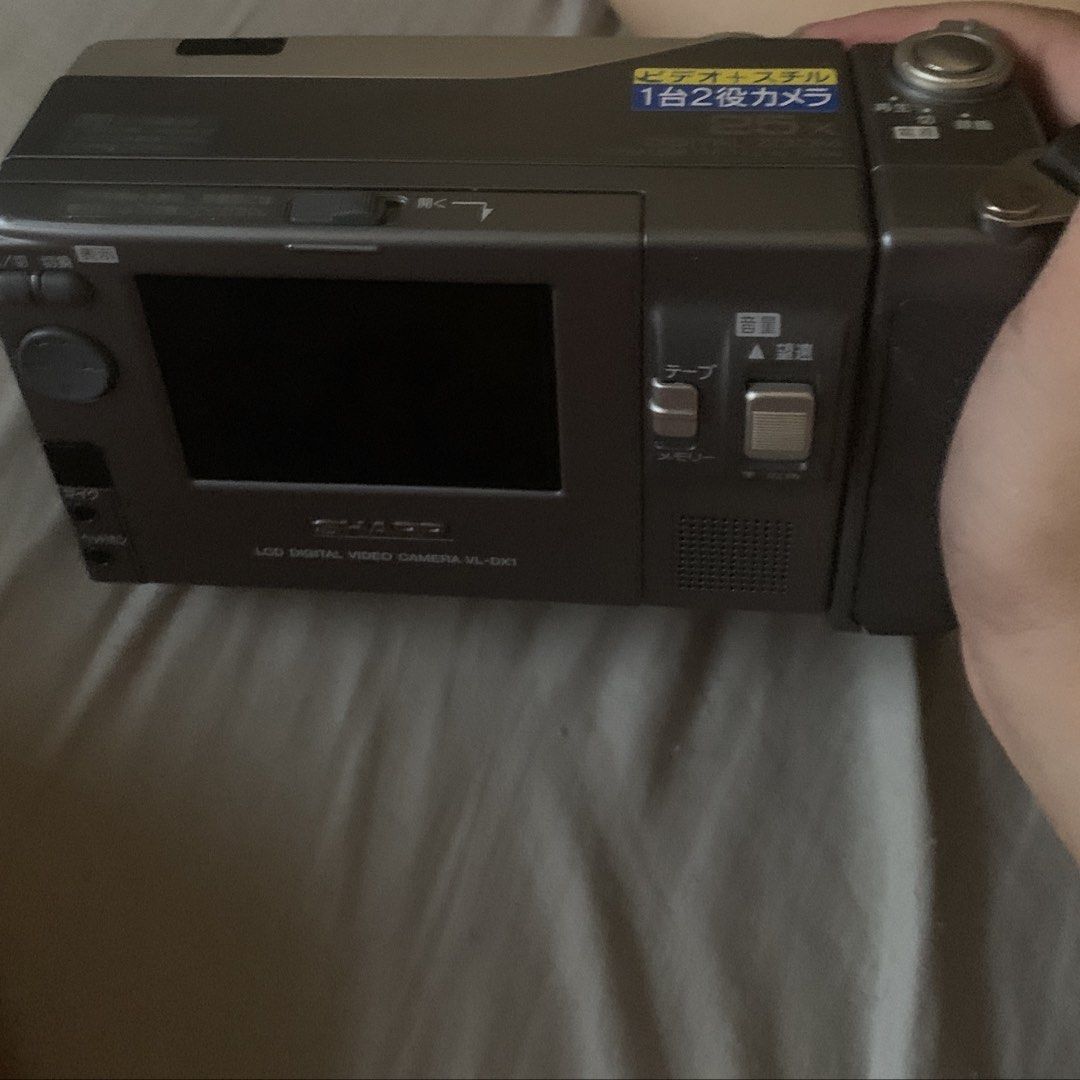 Sharp Digicam (Category: Cameras) located in Manila. Submitted by leiluh (Listing ID 1424022891, Image 2). Description: - Vintage Sharp Digital Viewcam VL-DX1 - Built-in LCD screen - Silver body with black grip - Includes hand strap - Mini DV slot - Untested - Perfect for retro-style videos/photos sample pics on the 3rd & 4th slide ^^.