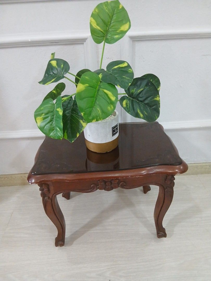 Side Table (Category: Tables & Sets) located in Singapore. Submitted by aliaini (Listing ID 1423991533, Image 3). Description: Selling small solid wood side table. Strong, sturdy and stable. length 49m. width 32m. ✨ Suitable as: Bedside table Living room side table TV stand for small TV Decorative corner table 📌 Condition: heavilt Used but well kept Minor signs of use Plant shown in photo is for decoration only (NOT included) Self-collect prefer