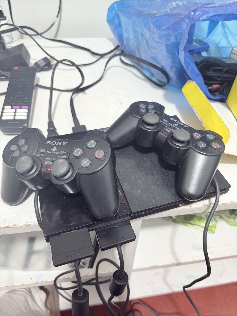 Sony PlayStation 2 Console with Controllers (Category: PlayStation) located in Manila. Submitted by amhylase_1031 (Listing ID 1423995669, Image 1). Description: - Sony PlayStation 2 console - Includes two black controllers - Two controller ports - Memory card slot - Includes all necessary cables - Black color - includes games (Tekken, 24 The Game, Lemmings, the Gladiator.