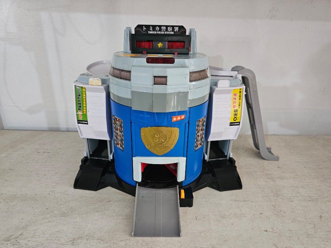 Tomica Police Station (Category: Vehicle & Diecast Models) located in Silang. Submitted by tsamba_omocha (Listing ID 1424031035, Image 2). Description: - Tom8ca Police Station - Transforming features. - Color scheme: blue, gray, white, yellow, and red. - Includes multiple opening and closing parts. - Features Japanese text accents. - Working battery not included. - Can provide video upon request.