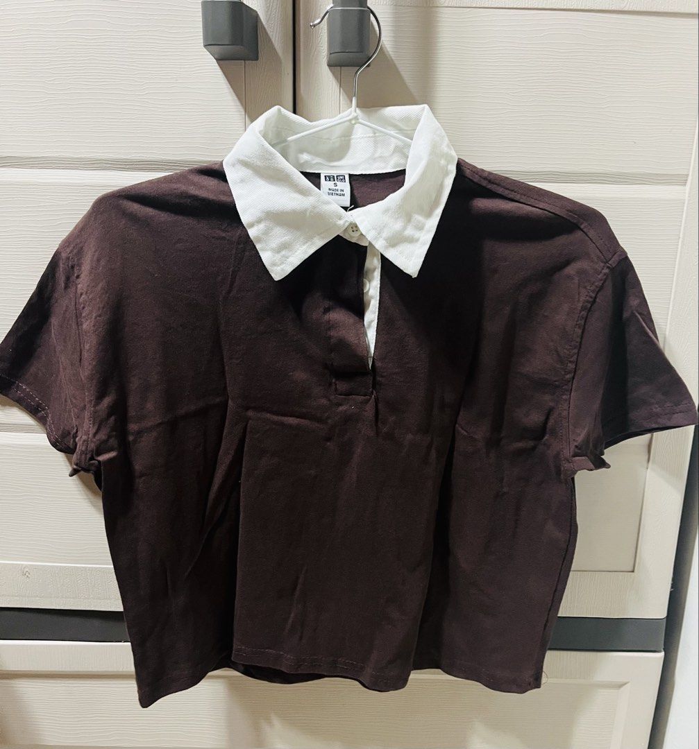 UNIQLO INSPIRED CROPPED COLLARED SHIRT (Category: Shirts) located in Bulacan. Submitted by neiijj (Listing ID 1424145755, Image 1). Description: USED ONCE‼️ DECLUTTERING- PERSONAL USE - Uniqlo Inspired Rugby Shirt - Color: Dark Brown with White Collar - Size: S-M - Features: Short Sleeves, Button-up Neckline - Made in Vietnam - Perfect for everyday wear.