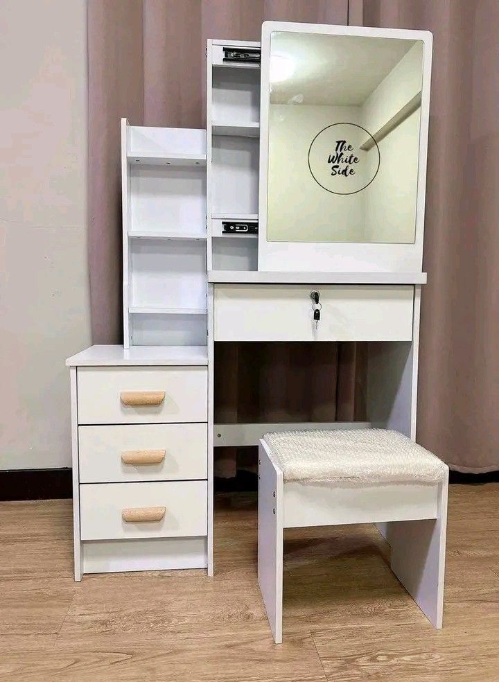 Vanity Table Set with Mirror and Stool (Category: Tables & Sets) located in Makati City. Submitted by oideme (Listing ID 1424082666, Image 1). Description: - Vanity table set complete with mirror and stool. - Features multiple drawers for storage. - Includes a side cabinet with shelves and drawers. - Available colors: White, Brown, and Pink. - Ideal for bedrooms and dressing areas. Provides a stylish and functional space..
