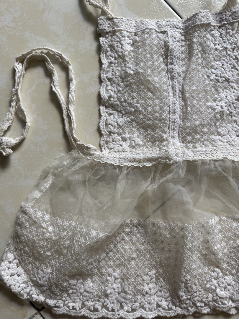 White Crochet Apron (Category: Coats, Jackets and Outerwear) located in Quezon City. Submitted by shndm25 (Listing ID 1424040690, Image 2). Description: - Delicate white crochet apron - Sheer, ruffled bottom - Adjustable straps - Waist ties - Floral crochet pattern - Perfect for kitchen or crafts - Adds vintage charm.