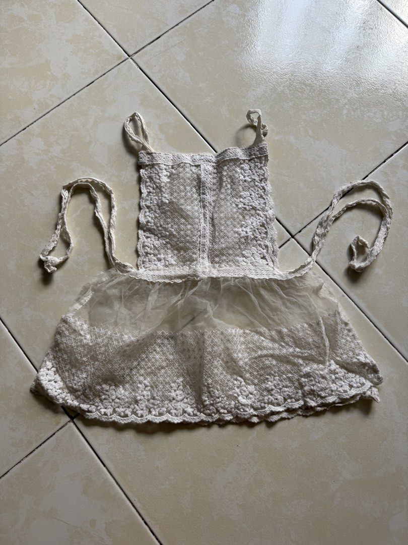 White Crochet Apron (Category: Coats, Jackets and Outerwear) located in Quezon City. Submitted by shndm25 (Listing ID 1424040690, Image 1). Description: - Delicate white crochet apron - Sheer, ruffled bottom - Adjustable straps - Waist ties - Floral crochet pattern - Perfect for kitchen or crafts - Adds vintage charm.