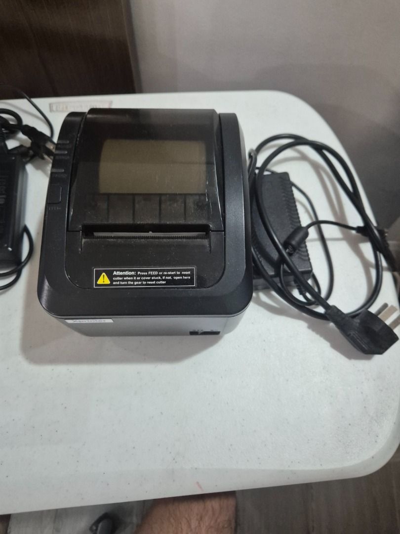 Xprinter XP-K200L thermal POS receipt printer (Category: Printers, Scanners & Copiers) located in Quezon City. Submitted by martn. (Listing ID 1424123744, Image 3). Description: This is an Xprinter XP-K200L thermal POS receipt printer. - Technology: Uses direct thermal printing technology, requiring no ink cartridges. - Speed: Capable of high-speed printing up to 200 mm/sec. - Paper Width: Supports 80mm thermal paper. - Features: Includes an auto