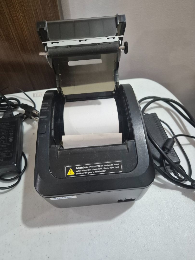 Xprinter XP-K200L thermal POS receipt printer (Category: Printers, Scanners & Copiers) located in Quezon City. Submitted by martn. (Listing ID 1424123744, Image 2). Description: This is an Xprinter XP-K200L thermal POS receipt printer. - Technology: Uses direct thermal printing technology, requiring no ink cartridges. - Speed: Capable of high-speed printing up to 200 mm/sec. - Paper Width: Supports 80mm thermal paper. - Features: Includes an auto