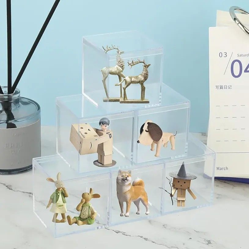 50mm Figure Display Box - sold each (Category: Storage Boxes & Baskets) located in Quezon City. Submitted by an.marie (Listing ID 1425756761, Image 2). Description: These clear acrylic display boxes are perfect for showcasing small items like figurines, collectibles, or craft supplies. They provide a clean and organized way to protect and display your items. The boxes are square-shaped with a removable lid, allowing easy access and arrangement. I