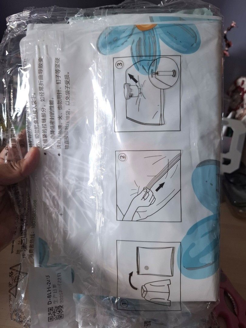 50x70cm Vacuum Storage Bag - sold each (Category: Storage Boxes & Baskets) located in Quezon City. Submitted by ana-chan (Listing ID 1425753178, Image 2). Description: These vacuum storage bags are 50x70cm in size. They are designed to compress clothing and other items for space-saving storage. The bags feature a floral design and include instructions for use. They are ideal for organizing and protecting items from dust and moisture. Each bag is 