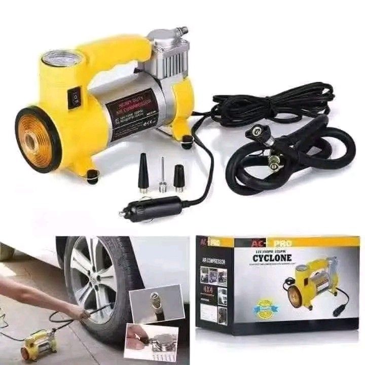 AC Pro Cyclone 12V Air Compressor (Category: Construction Tools & Equipment) located in Quezon City. Submitted by anghies_shop (Listing ID 1425664562, Image 1). Description: AC Pro Cyclone 12V air compressor for car tires. Includes multiple nozzle attachments and a power cable with a cigarette lighter adapter. The unit is yellow and silver with a built-in pressure gauge. The box shows the product name and a picture of the compressor..
