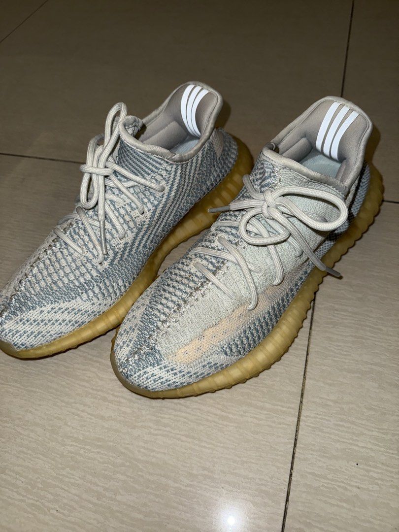 Adidas Yeezy Boost 350 V2 Blue Tint (Category: Sneakers) located in Manila. Submitted by terefficstuffs (Listing ID 1425749613, Image 3). Description: Adidas Yeezy Boost 350 V2 in a blue tint colorway. Features a Primeknit upper with a blue and white pattern. The midsole has a translucent, yellowish appearance. Includes the signature side stripe and heel tab. The laces are light grey..