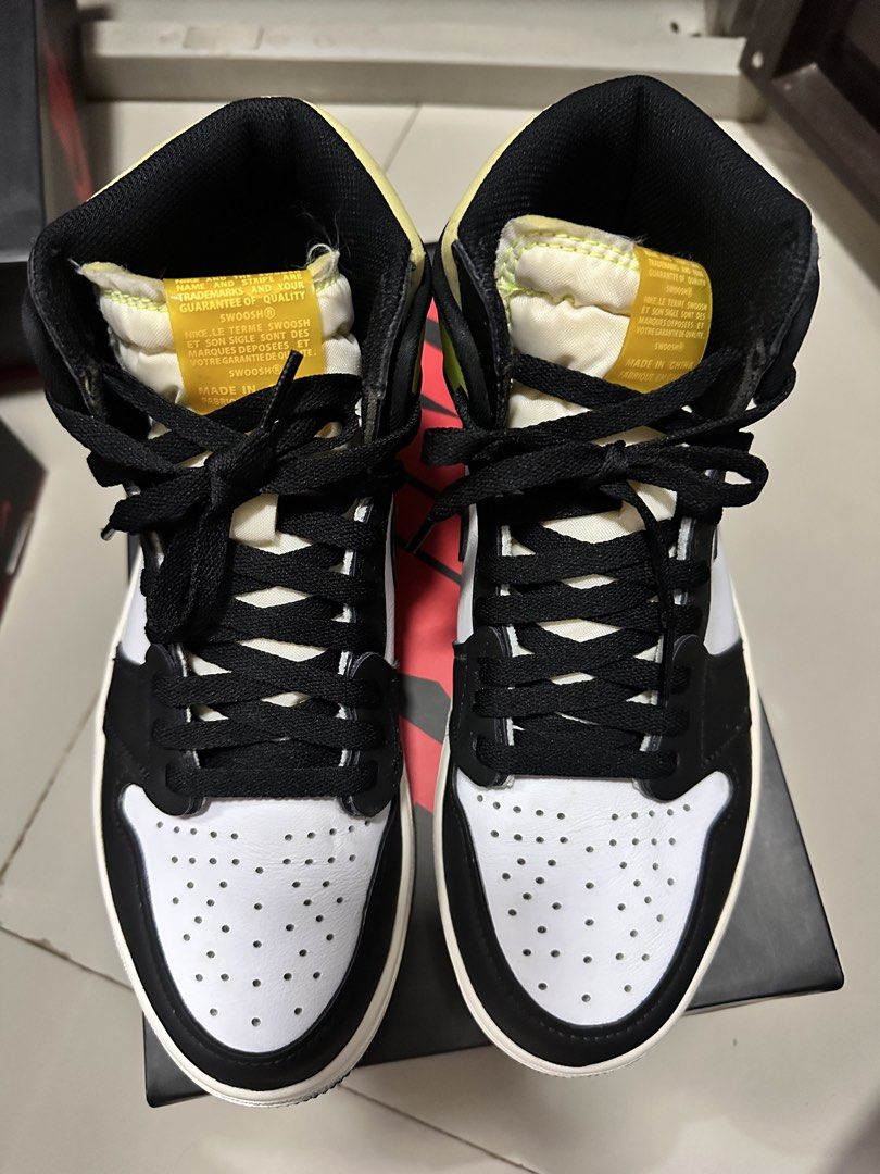 Air Jordan 1 Retro High OG Volt Gold (Category: Sneakers) located in Lipa City. Submitted by mochii13 (Listing ID 1425646489, Image 2). Description: Air Jordan 1 Retro High OG Volt Gold sneakers. Features a black, white, and volt yellow colorway. The shoes are high-top with a classic design. Includes the original box. The size is US 8.5. The shoes have black laces and a white midsole. Last pic for reference only FREE SHIPPING.