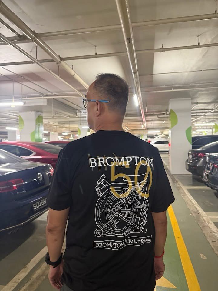Brompton 50th Anniversary T-Shirt (Category: Parts & Accessories) located in Singapore. Submitted by stellatey23 (Listing ID 1425665658, Image 2). Description: Brompton 50th Anniversary T-shirt. Features a unique design on the back and a small logo on the front. Made of a comfortable, breathable material. Perfect for Brompton enthusiasts or anyone looking for a stylish, commemorative tee. Microfiber dri fit, quick dry fabric material. Size S till