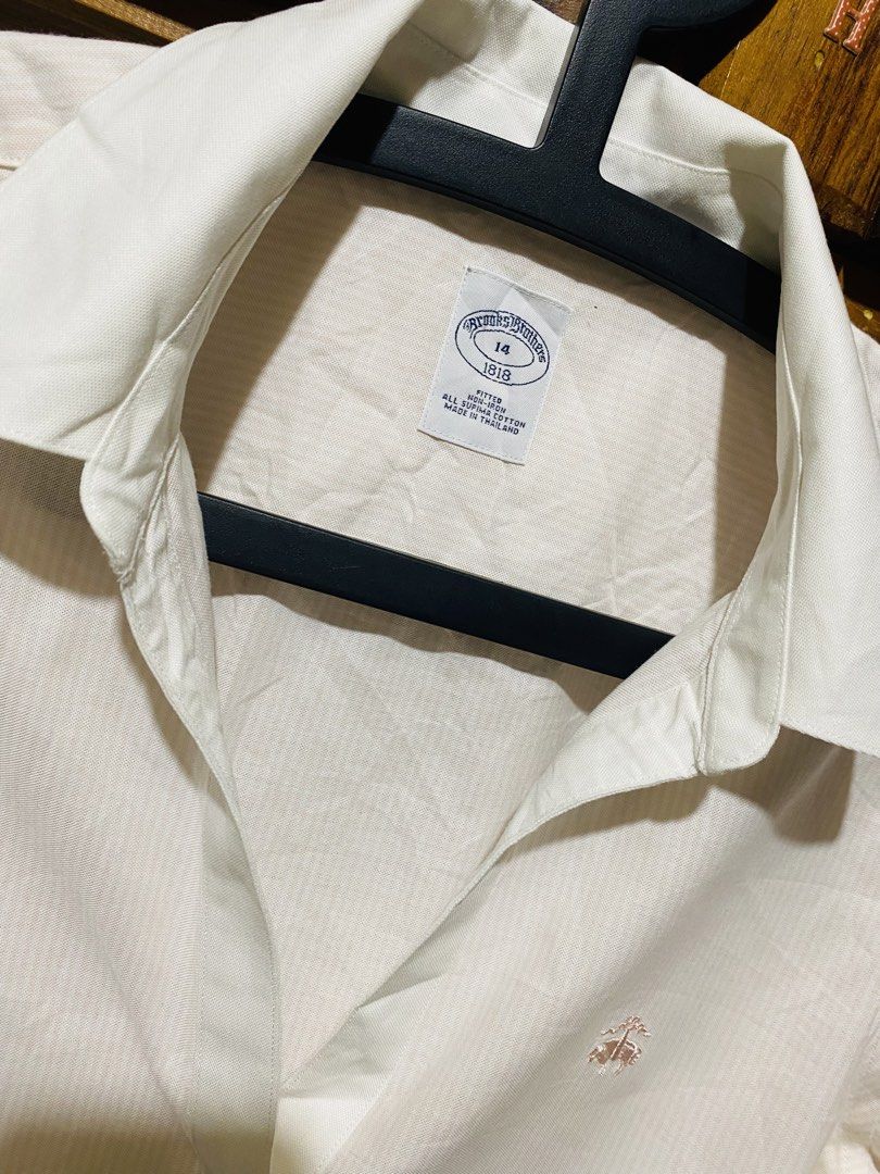 Brooks Brothers Button-Down Shirt (Category: Formal Shirts) located in Baguio. Submitted by vanity_kimo (Listing ID 1425696703, Image 2). Description: Cream-colored button-down shirt from Brooks Brothers. Features a classic collar and long sleeves with buttoned cuffs. The shirt has a subtle striped pattern and the Brooks Brothers logo embroidered on the chest. Size 14. 🍀EXCELLENT USE CONDITION 👌.