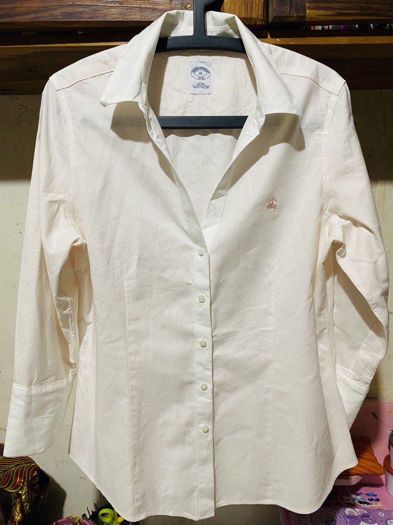 Brooks Brothers Button-Down Shirt (Category: Formal Shirts) located in Baguio. Submitted by vanity_kimo (Listing ID 1425696703, Image 1). Description: Cream-colored button-down shirt from Brooks Brothers. Features a classic collar and long sleeves with buttoned cuffs. The shirt has a subtle striped pattern and the Brooks Brothers logo embroidered on the chest. Size 14. 🍀EXCELLENT USE CONDITION 👌.
